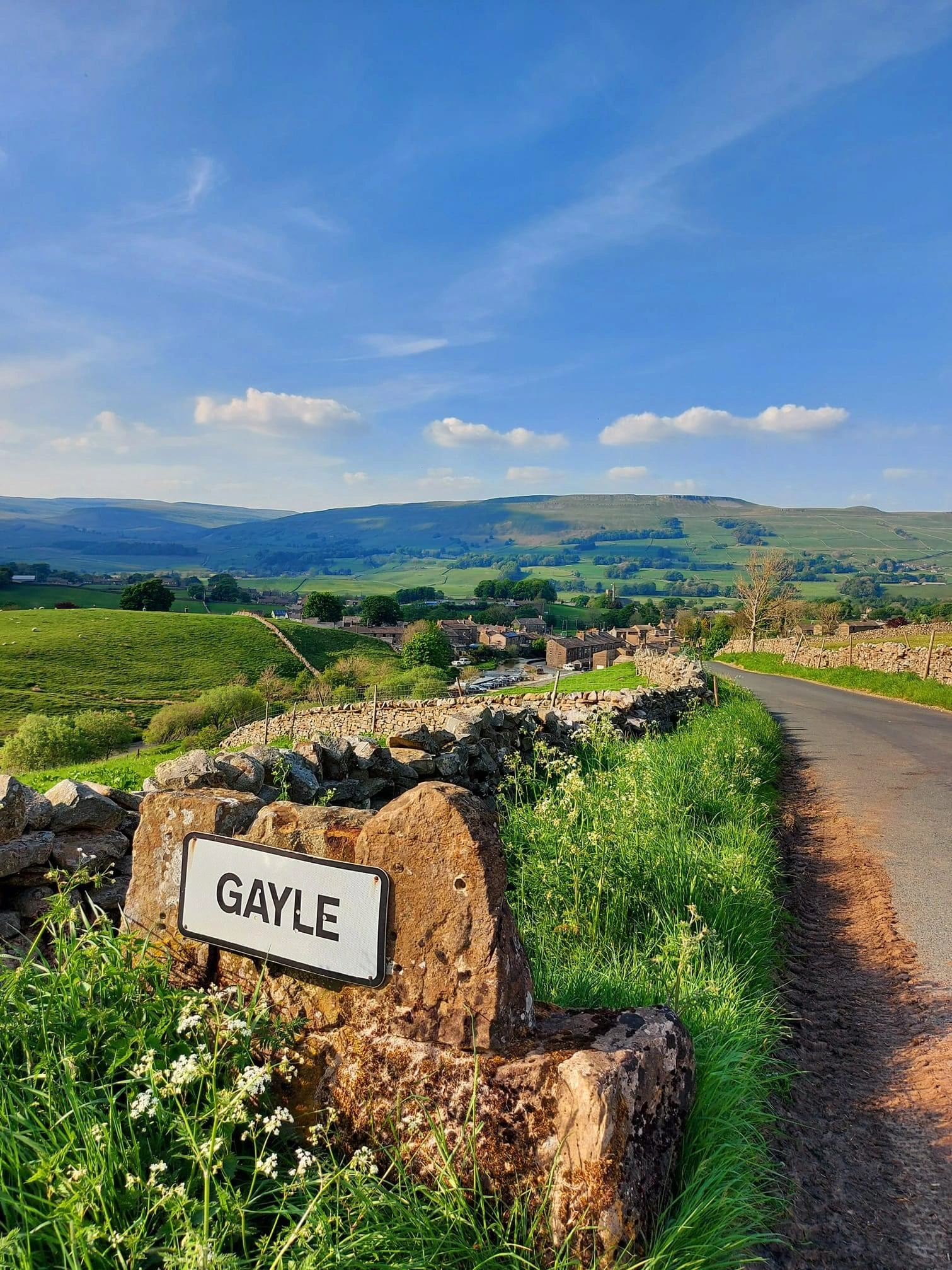 landscape in the Yorkshire Dales including stone signposting the small hamlet of Gayle